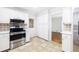 Well-lit kitchen features stainless steel appliances, tile backsplash, and white cabinetry at 255 Jade Cove Dr, Roswell, GA 30075