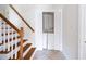 Hallway view of laundry closet with folding doors and stairs with wood railings at 255 Jade Cove Dr, Roswell, GA 30075