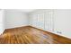 Well-lit living room showcasing hardwood floors and bright walls with large window with white shutters at 255 Jade Cove Dr, Roswell, GA 30075