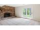 Room featuring a brick fireplace and access to the backyard through French doors at 255 Jade Cove Dr, Roswell, GA 30075