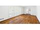 Spacious living room with hardwood floors and large window with shutters, offering ample natural light at 255 Jade Cove Dr, Roswell, GA 30075