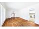 Open living room with hardwood floors connecting to the kitchen and staircase to upper level at 255 Jade Cove Dr, Roswell, GA 30075
