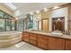 Bathroom showcasing a dual sink vanity with granite countertop, soaking tub and skylight at 562 Pine Valley Se Rd, Marietta, GA 30067