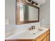 Updated bathroom with quartz countertop and decorative mirror at 562 Pine Valley Se Rd, Marietta, GA 30067