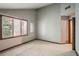 Bedroom with neutral walls and carpet, a window with blinds, and wood trim accents at 562 Pine Valley Se Rd, Marietta, GA 30067