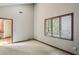 Bright bedroom featuring neutral carpet, a large window with blinds, and a wood trimmed doorway at 562 Pine Valley Se Rd, Marietta, GA 30067