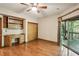 Bedroom with built-in desk and shelves, wood floors, and sliding glass door to the deck at 562 Pine Valley Se Rd, Marietta, GA 30067