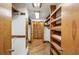 Walk-in closet featuring custom wood shelving and storage system at 562 Pine Valley Se Rd, Marietta, GA 30067