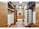 Walk-in closet with custom wood shelves and storage, leading to bathroom at 562 Pine Valley Se Rd, Marietta, GA 30067