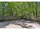 Wooden deck surrounded by trees, with built-in seating and natural views at 562 Pine Valley Se Rd, Marietta, GA 30067