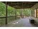 A partially covered outdoor deck featuring wood railings, offering serene views of the surrounding lush greenery at 562 Pine Valley Se Rd, Marietta, GA 30067