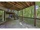 An outdoor deck area with wooden railings and stairs leading to a lower level surrounded by lush greenery at 562 Pine Valley Se Rd, Marietta, GA 30067