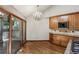 Dining room with wood floors, modern chandelier, wood cabinets and sliding doors to the patio at 562 Pine Valley Se Rd, Marietta, GA 30067