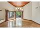 Open dining room area featuring hardwood floors, wood ceiling, chandelier, and large windows at 562 Pine Valley Se Rd, Marietta, GA 30067