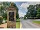 Stone sign at Atlanta Country Club entrance with well-manicured lawns along the road at 562 Pine Valley Se Rd, Marietta, GA 30067