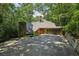 Unique home exterior with stone accents, skylight, mature trees, and attached garage at 562 Pine Valley Se Rd, Marietta, GA 30067