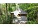 Secluded home with stone details, nestled amongst mature trees and private drive way at 562 Pine Valley Se Rd, Marietta, GA 30067