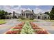 Magnificent estate boasts a stone facade, flower beds, manicured lawn, and a circular driveway at 562 Pine Valley Se Rd, Marietta, GA 30067