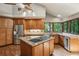 Full kitchen showcasing wood cabinets, stainless steel appliances, island, granite countertops and hardwood floors at 562 Pine Valley Se Rd, Marietta, GA 30067