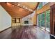 Bright living room with stone fireplace, wood ceiling, hardwood floors, and large windows at 562 Pine Valley Se Rd, Marietta, GA 30067