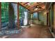 Covered patio area with wood floors, a water feature, and a view of the surrounding greenery at 562 Pine Valley Se Rd, Marietta, GA 30067