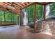 Covered patio with skylights, ceiling fans and stone accents overlooking serene landscaping at 562 Pine Valley Se Rd, Marietta, GA 30067
