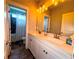 Well-lit bathroom featuring double sinks, a large mirror, and a separate shower area at 848 Rolling Nw Hl, Kennesaw, GA 30152