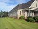 Well-maintained home exterior with lush lawn, showcasing stone accents and a manicured landscape at 848 Rolling Nw Hl, Kennesaw, GA 30152