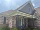 Charming home featuring a stone facade and inviting front porch with decorative shutters and well-manicured landscaping at 848 Rolling Nw Hl, Kennesaw, GA 30152