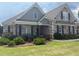 Charming home featuring stone and siding, a manicured lawn, and an inviting covered front porch with decorative shutters at 848 Rolling Nw Hl, Kennesaw, GA 30152