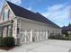 Spacious three-car garage with modern doors, complementing the home's exterior with clean lines and ample parking space at 848 Rolling Nw Hl, Kennesaw, GA 30152