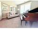 Cozy living room featuring a piano, comfortable seating, and decorative mirrors at 848 Rolling Nw Hl, Kennesaw, GA 30152
