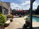 Backyard pool area with comfortable lounge chairs, lush landscaping, and privacy fencing at 848 Rolling Nw Hl, Kennesaw, GA 30152