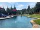Inviting backyard pool with a water feature and manicured lawn at 848 Rolling Nw Hl, Kennesaw, GA 30152