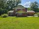 Brick two-story home with a chimney and a spacious backyard at 1106 Sharonton Way, Stone Mountain, GA 30083