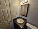 A half bath featuring a sink with gray countertops, modern fixtures, and gray walls at 1106 Sharonton Way, Stone Mountain, GA 30083