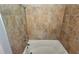 This is a bathroom tub and shower with brown patterned tiling at 1106 Sharonton Way, Stone Mountain, GA 30083