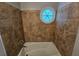 Bathroom features a shower-tub combination and a unique round window at 1106 Sharonton Way, Stone Mountain, GA 30083