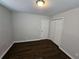 This is a bedroom with hardwood floors, neutral walls, and a white closet and door at 1106 Sharonton Way, Stone Mountain, GA 30083