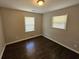 This is a bedroom with hardwood floors and two windows with light coming through them at 1106 Sharonton Way, Stone Mountain, GA 30083