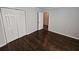 Cozy bedroom with hardwood floors, featuring double closets and neutral-toned walls at 1106 Sharonton Way, Stone Mountain, GA 30083