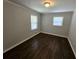 This is a bedroom with hardwood floors, neutral walls and light coming through the windows at 1106 Sharonton Way, Stone Mountain, GA 30083