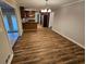 An open dining area with modern wood floors, seamlessly connected to the kitchen at 1106 Sharonton Way, Stone Mountain, GA 30083