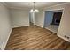 Dining room showcasing wood floors and a chandelier, flowing to the fireplace in the living room at 1106 Sharonton Way, Stone Mountain, GA 30083