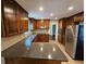 Well-lit kitchen featuring wooden cabinetry, stainless steel appliances, and a speckled granite countertop at 1106 Sharonton Way, Stone Mountain, GA 30083