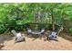 Cozy backyard seating area with comfortable chairs around a fire pit, perfect for outdoor gatherings at 127 Bradshaw Park Dr, Woodstock, GA 30188