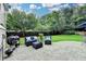 Inviting backyard patio with comfortable seating, BBQ grill, and manicured lawn for outdoor enjoyment at 127 Bradshaw Park Dr, Woodstock, GA 30188
