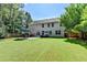 Expansive backyard featuring a patio, seating, a well-kept lawn, and the home's exterior with ample windows at 127 Bradshaw Park Dr, Woodstock, GA 30188