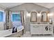 Chic bathroom featuring a clawfoot tub, marble floors, and a double vanity with stylish mirrors at 127 Bradshaw Park Dr, Woodstock, GA 30188