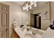 Bright bathroom with a double sink vanity, a large mirror, and a stylish lighting fixture at 127 Bradshaw Park Dr, Woodstock, GA 30188